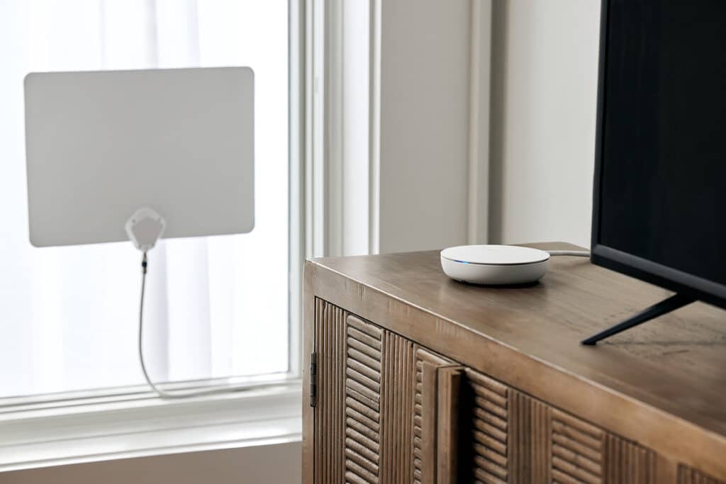 Tablo on TV stand near antenna in window