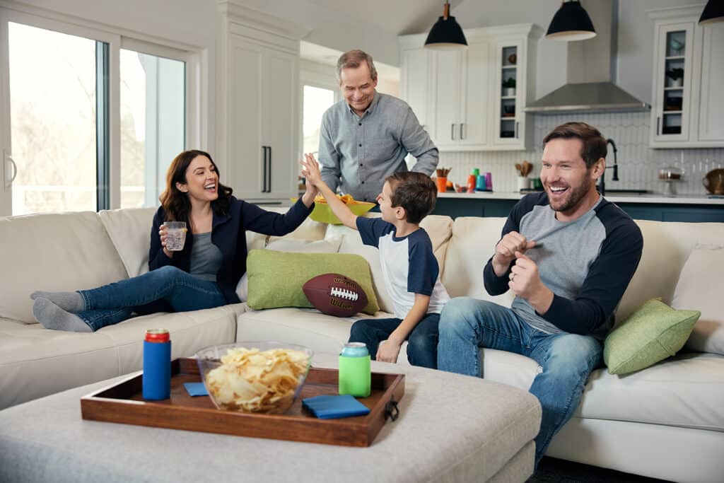 Family enjoying football in the living room