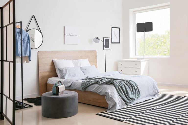 Tablo on dresser with antenna in the window of a bedroom