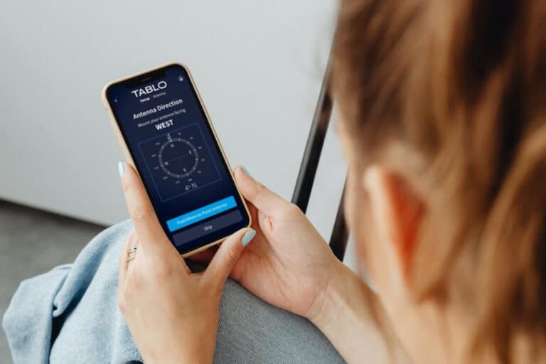 Woman using the Antenna Setup Wizard in the Tablo app.