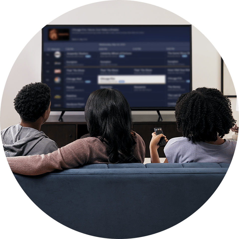 Mom, son and daughter picking something to watch on Tablo on the living room smart TV