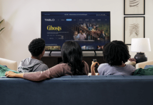 Mother and two teenagers exploring Tablo home screen while sitting on the couch