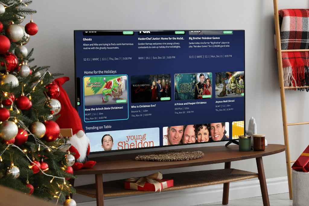 Tablo Home For the Holidays home screen row on a TV in a living room decorated for the holidays