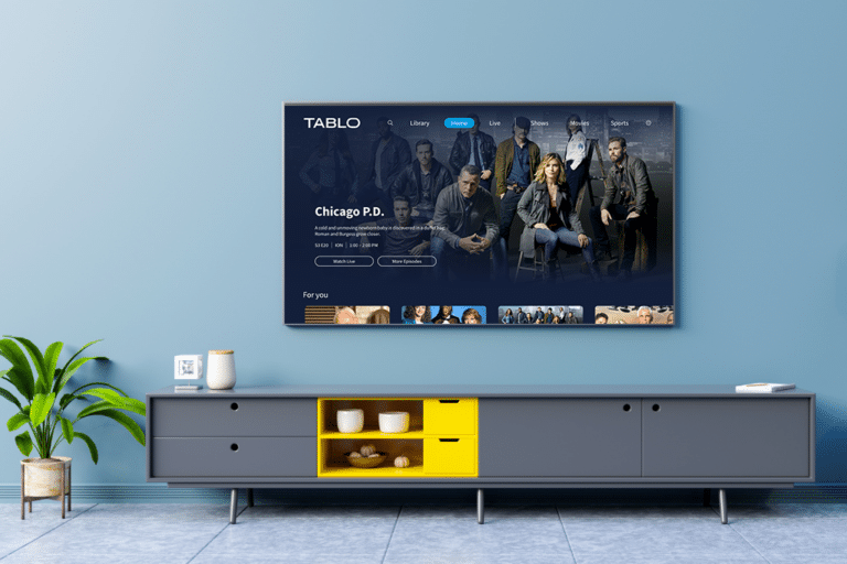 Tablo home screen showing Chicago PD on a television in a living room with a grey and yellow TV stand