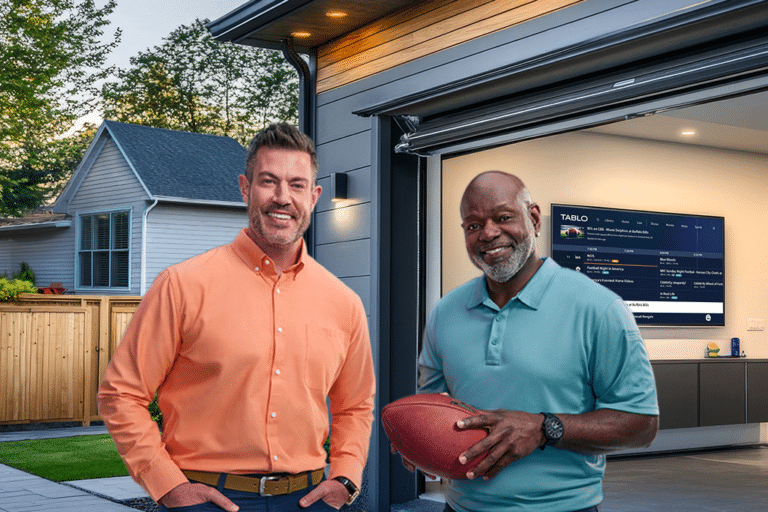 Emmit and Jessie, outside a garage with a TV running Tablo.