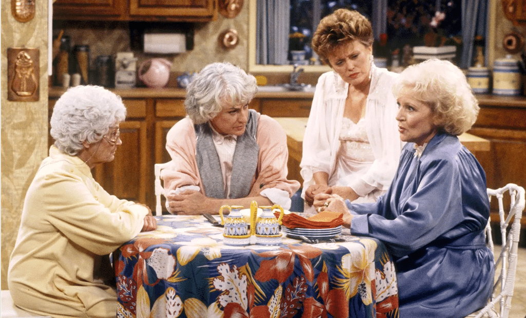 The Golden girls sitting around their table in their kitchen