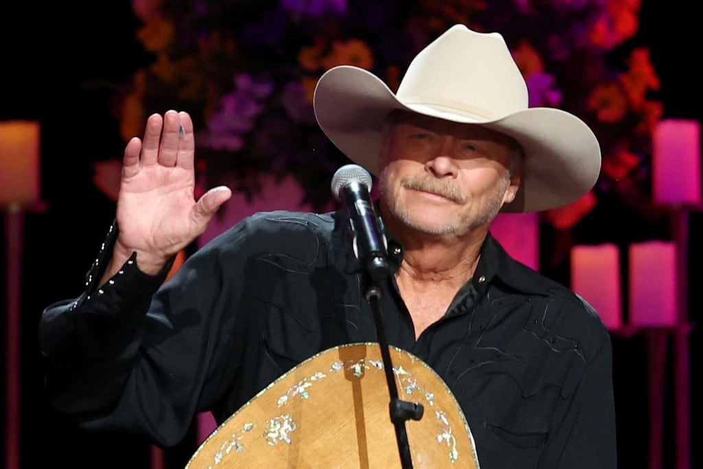 Alan Jackson, on stage, waving.